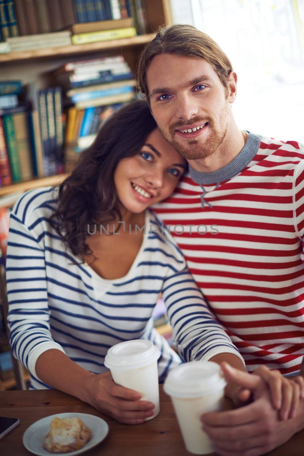 Amorous sweethearts sitting in cafe