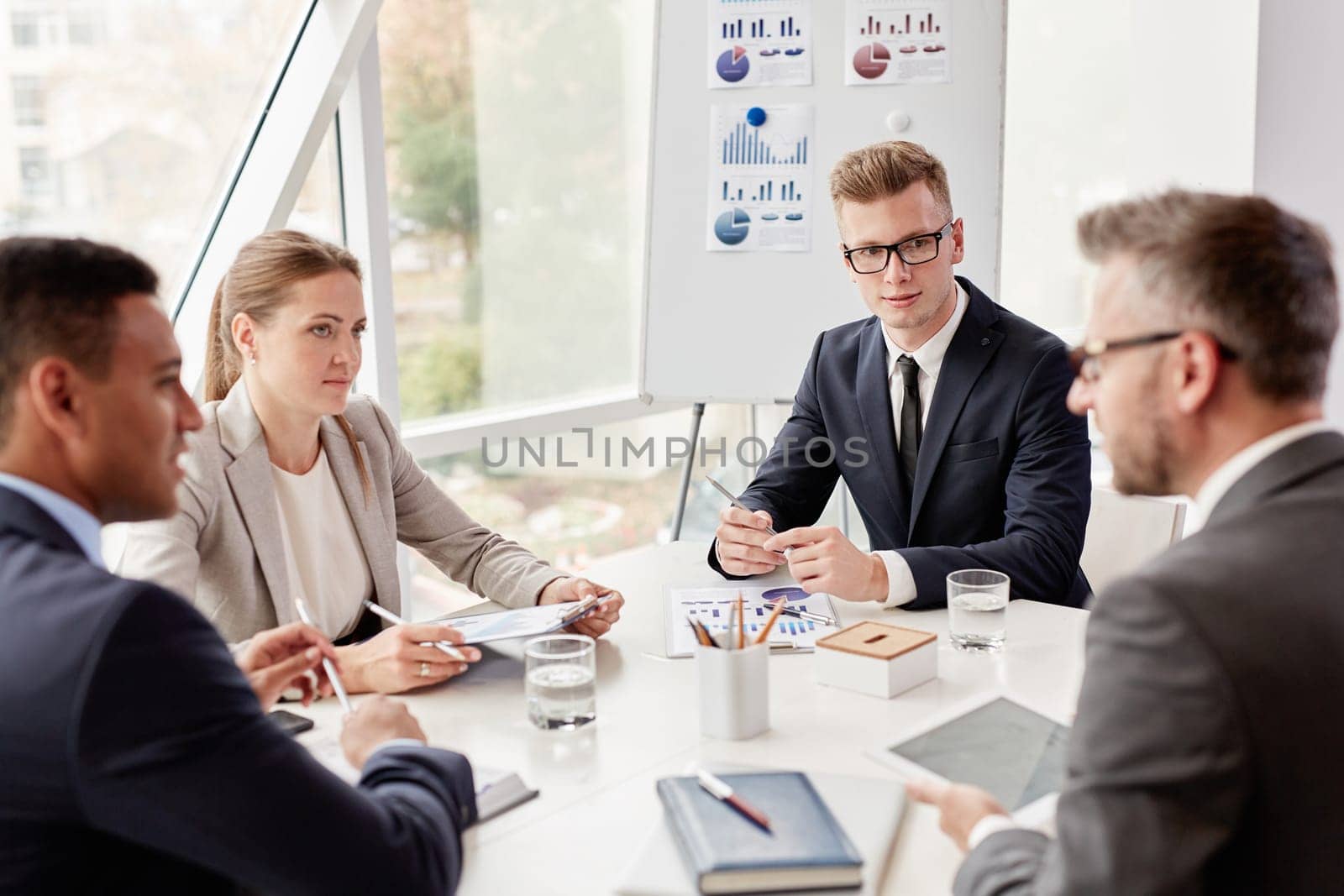 Group of confident colleagues planning work at meeting