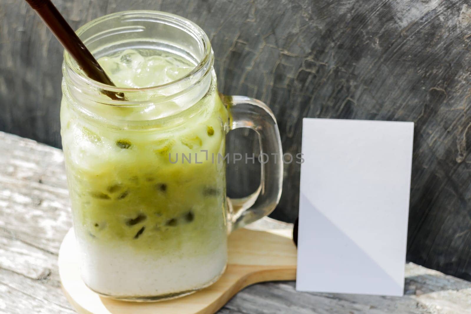 Iced green tea latte with blank name card, stock photo