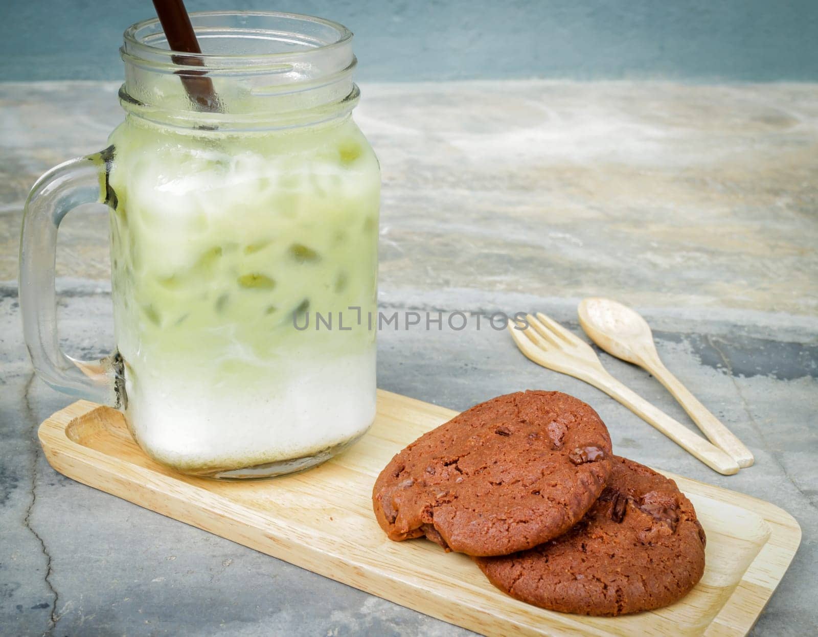 Iced green tea latte and chocolate cookies, stock photo