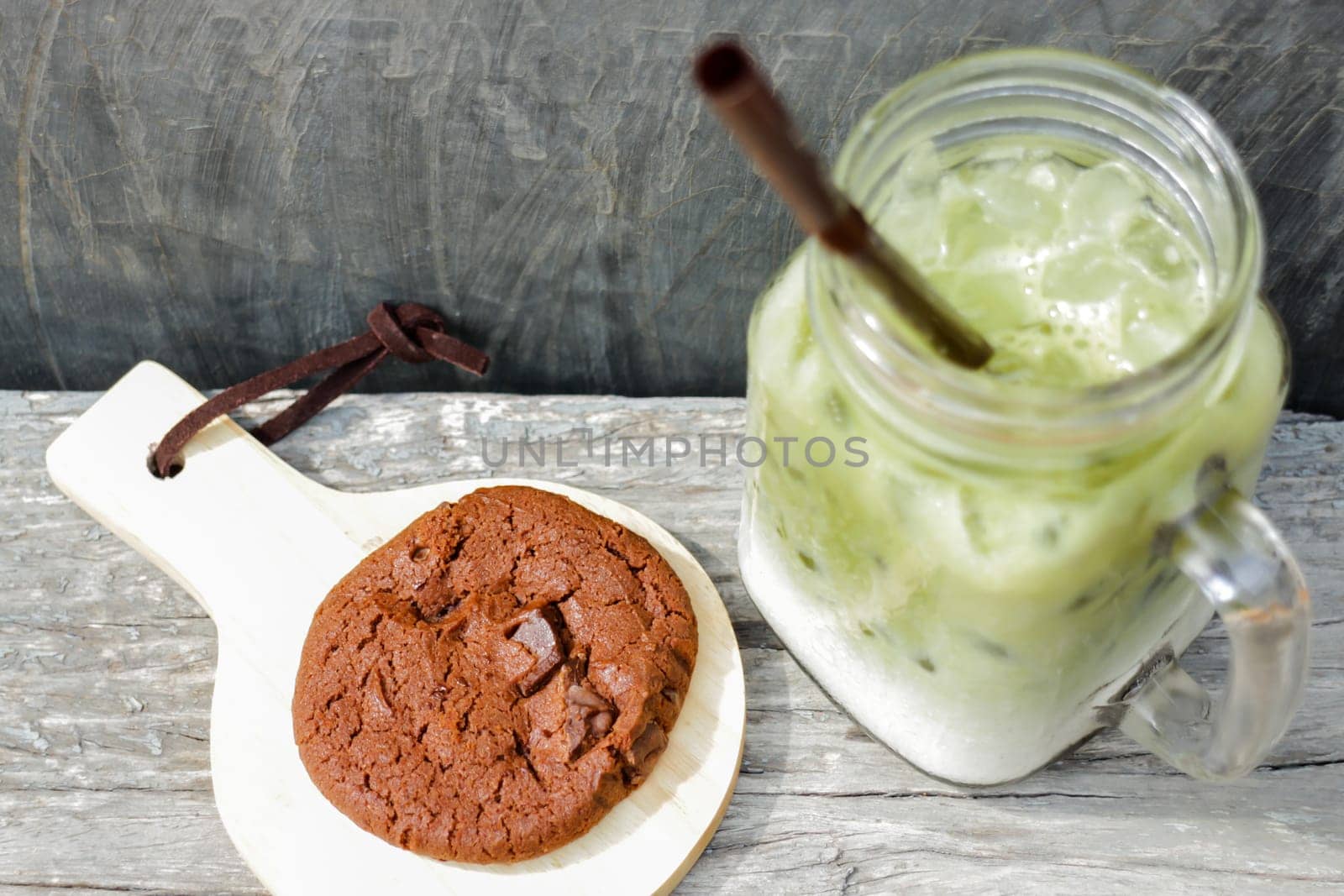 Iced green tea latte and chocolate cookies, stock photo
