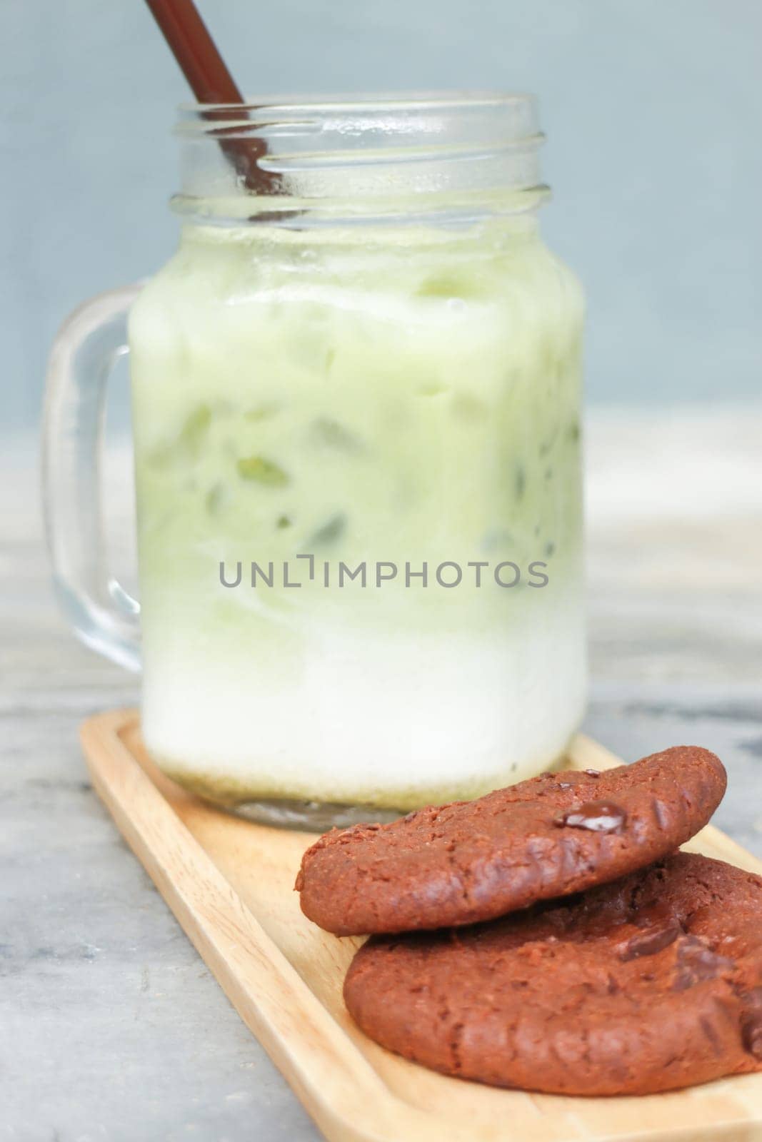 Iced green tea latte and chocolate cookies, stock photo