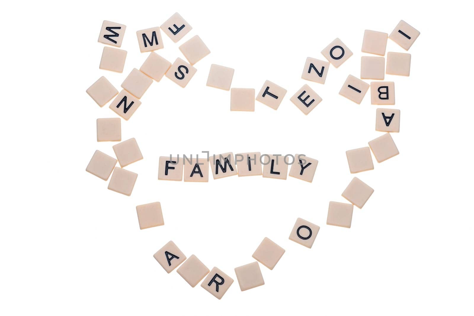 Small game tiles with letters on them arranged in a heart surrounding the word "love"" isolated on a white background."