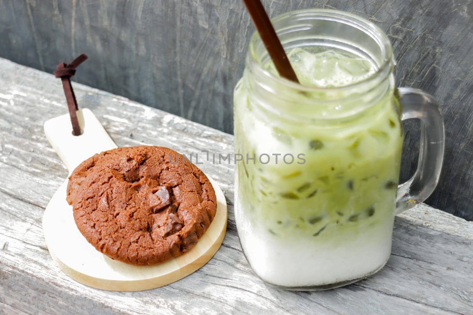 Iced green tea latte and chocolate cookies, stock photo