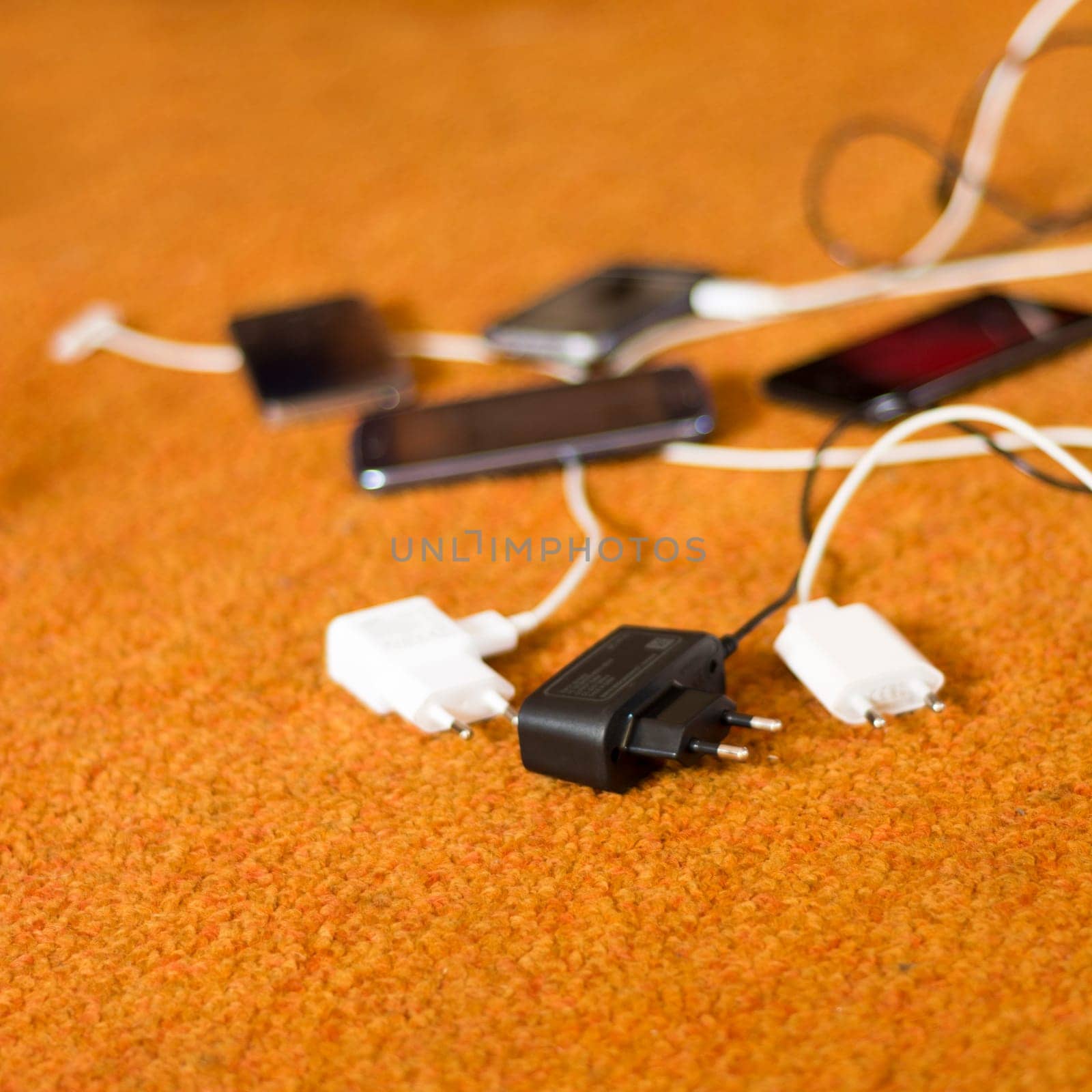 Phone Chargers on the orange carpet floor
