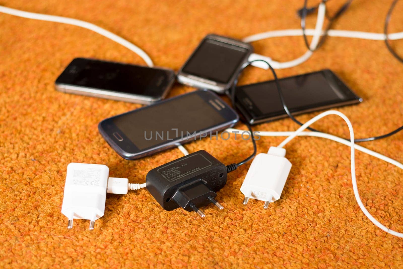 Phone Chargers on the orange carpet floor