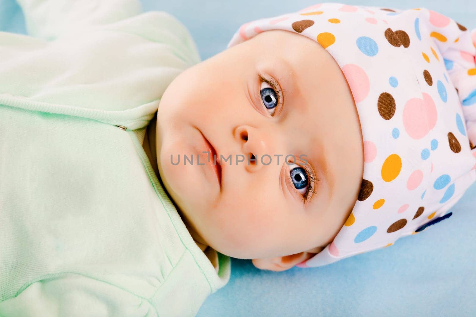 Charming baby girl in a hat. Studio
