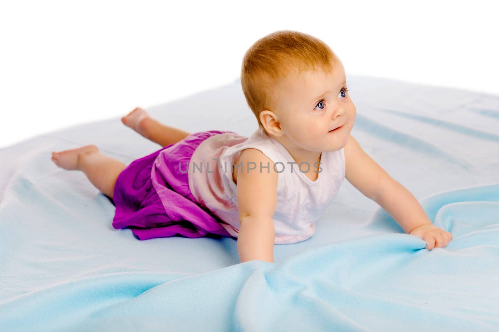 Charming baby girl in a dress. Studio