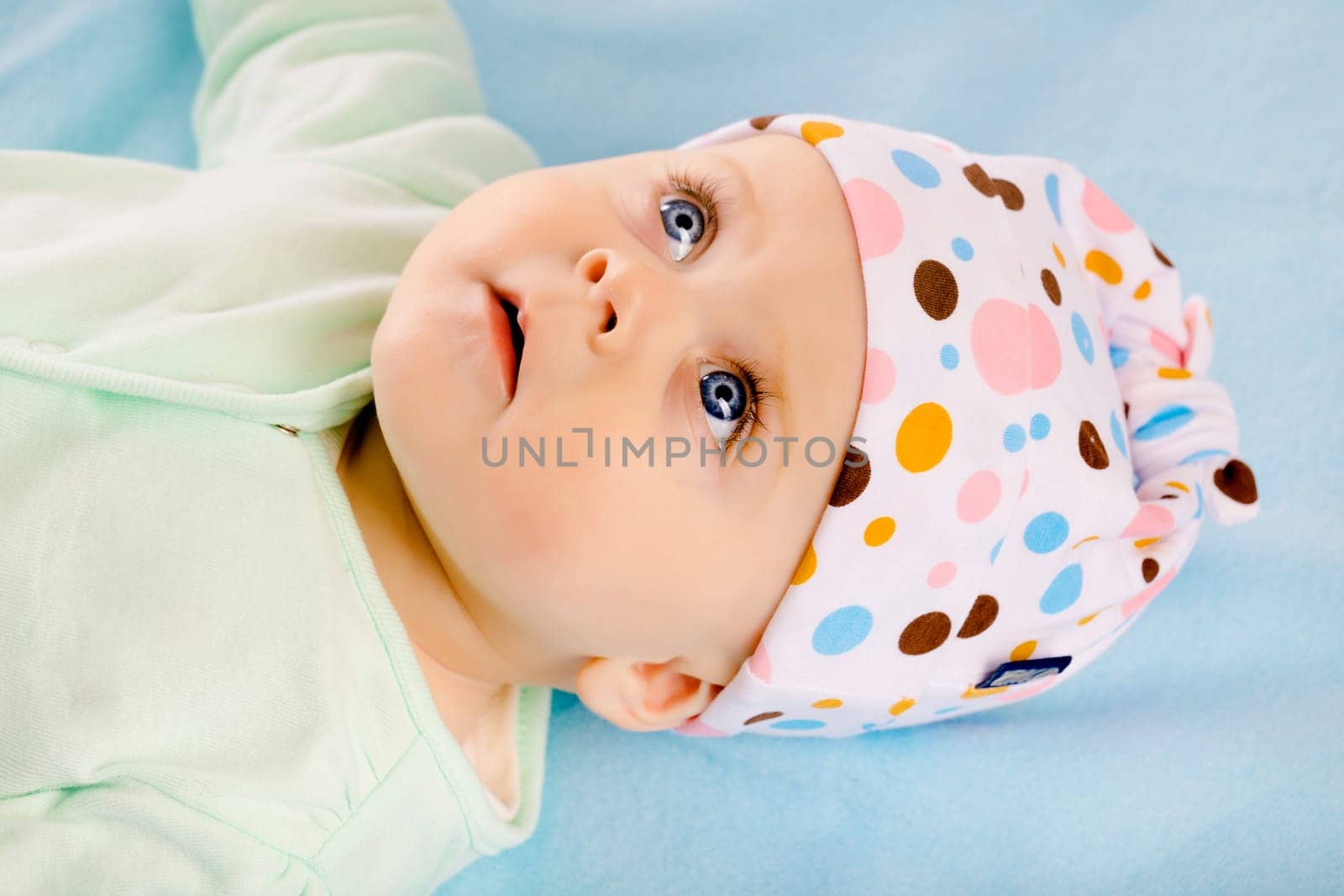 Charming baby girl in a hat. Studio