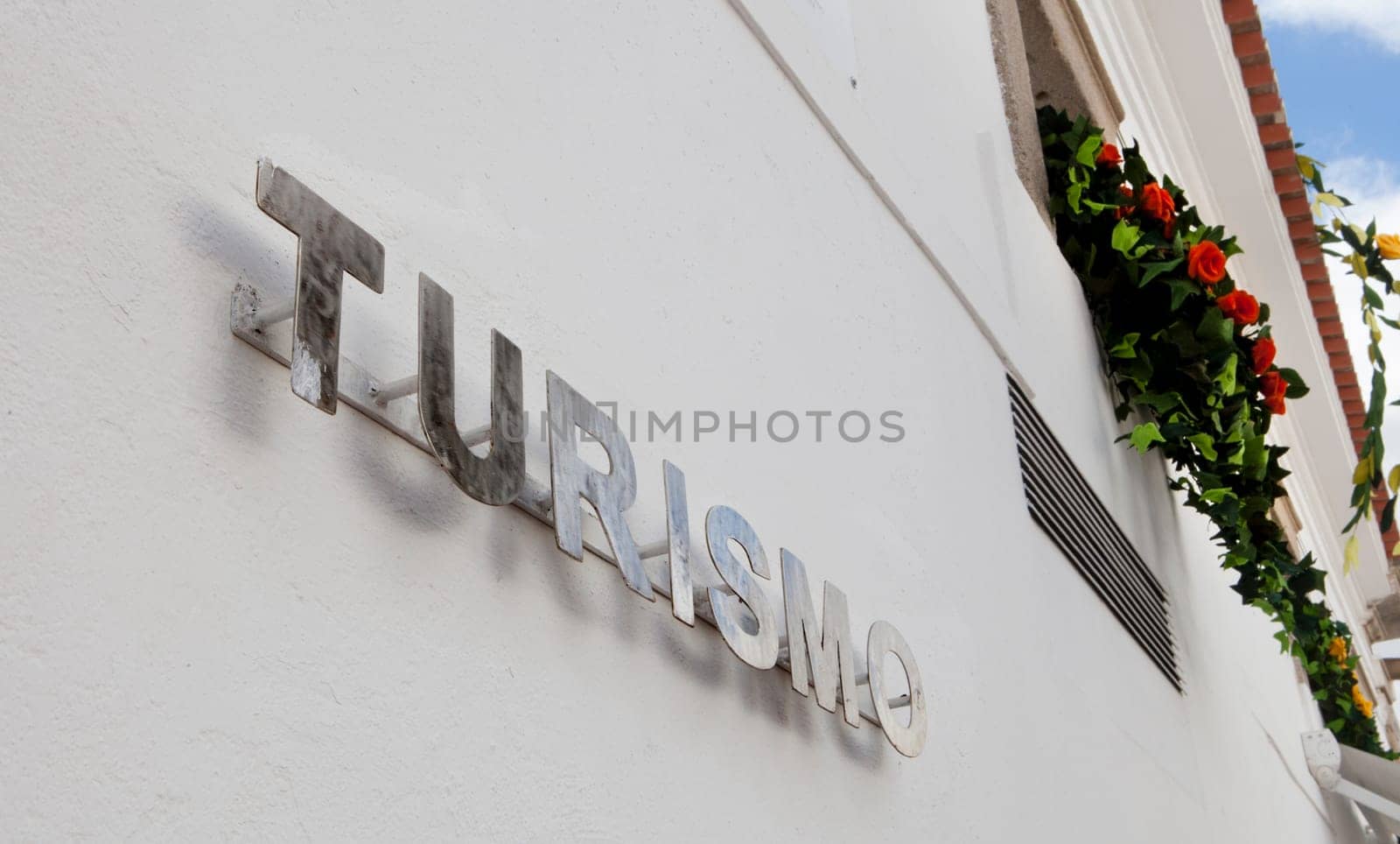 Metallic letters for a typical office of tourism at mediterranean town