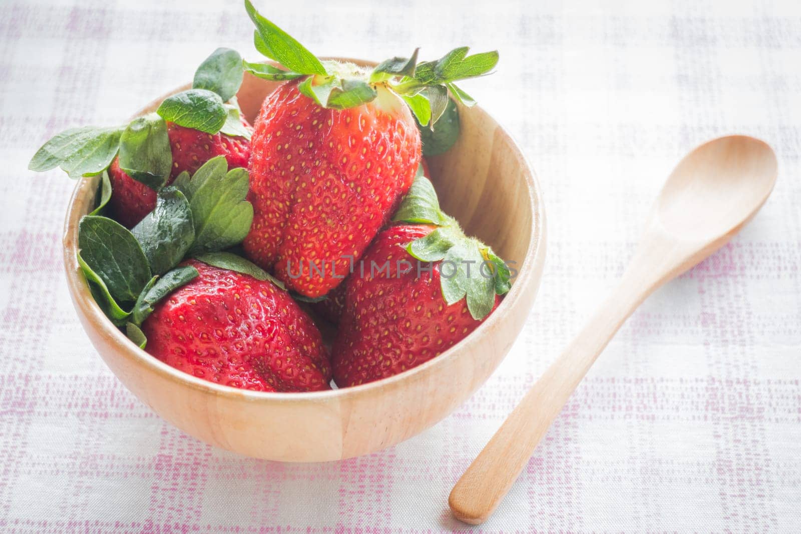 Fresh strawberry on wooden bowl, stock photo