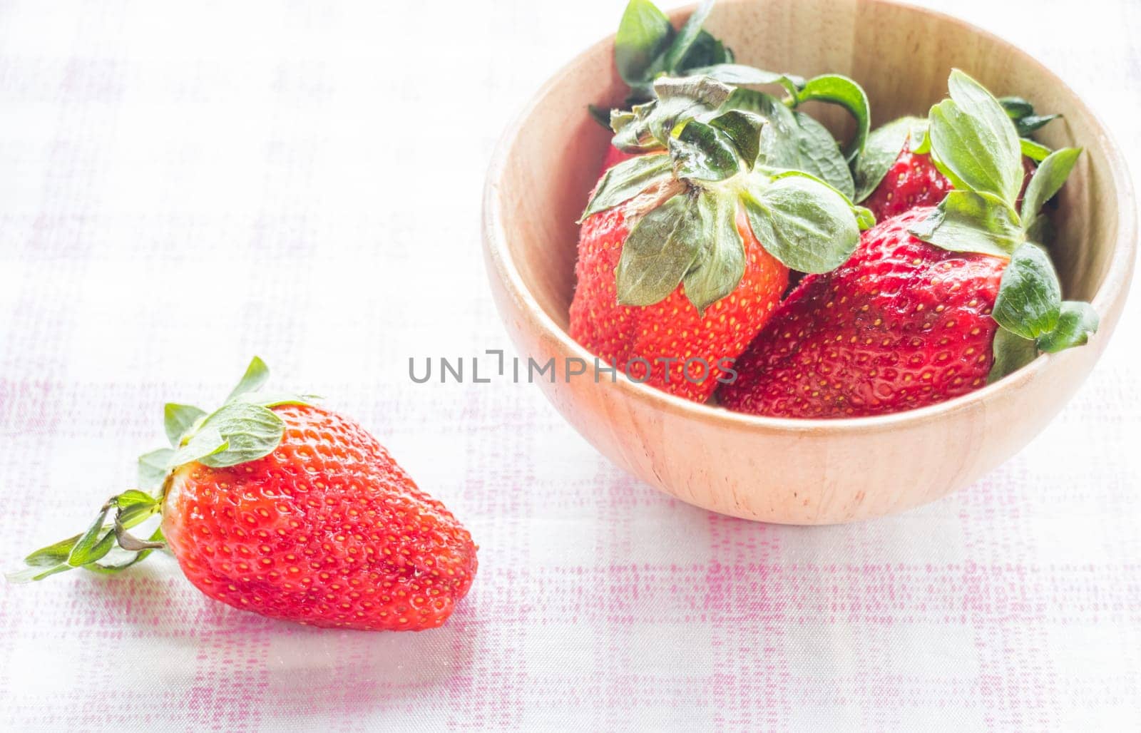 Fresh strawberry on wooden bowl, stock photo