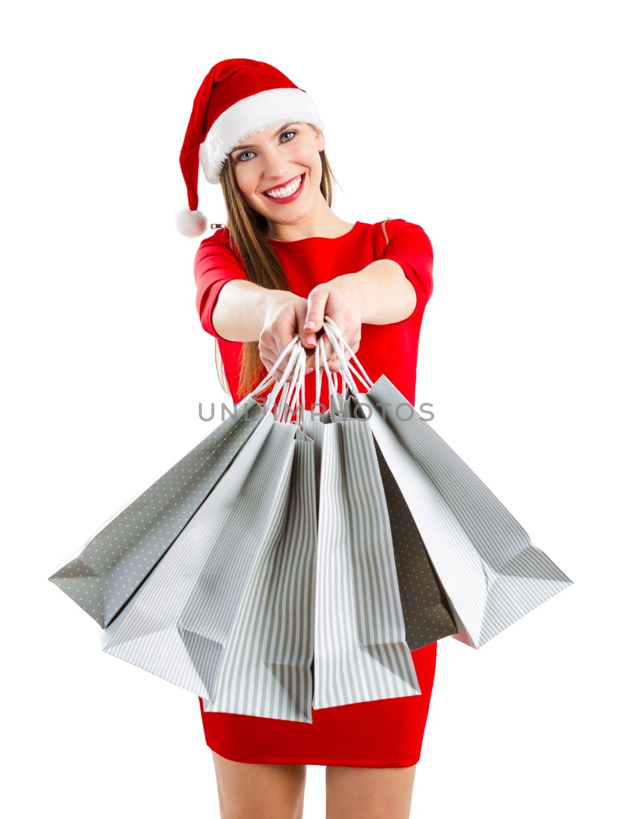 Beautiful and attractive woman with a santa hat holding shopping bags