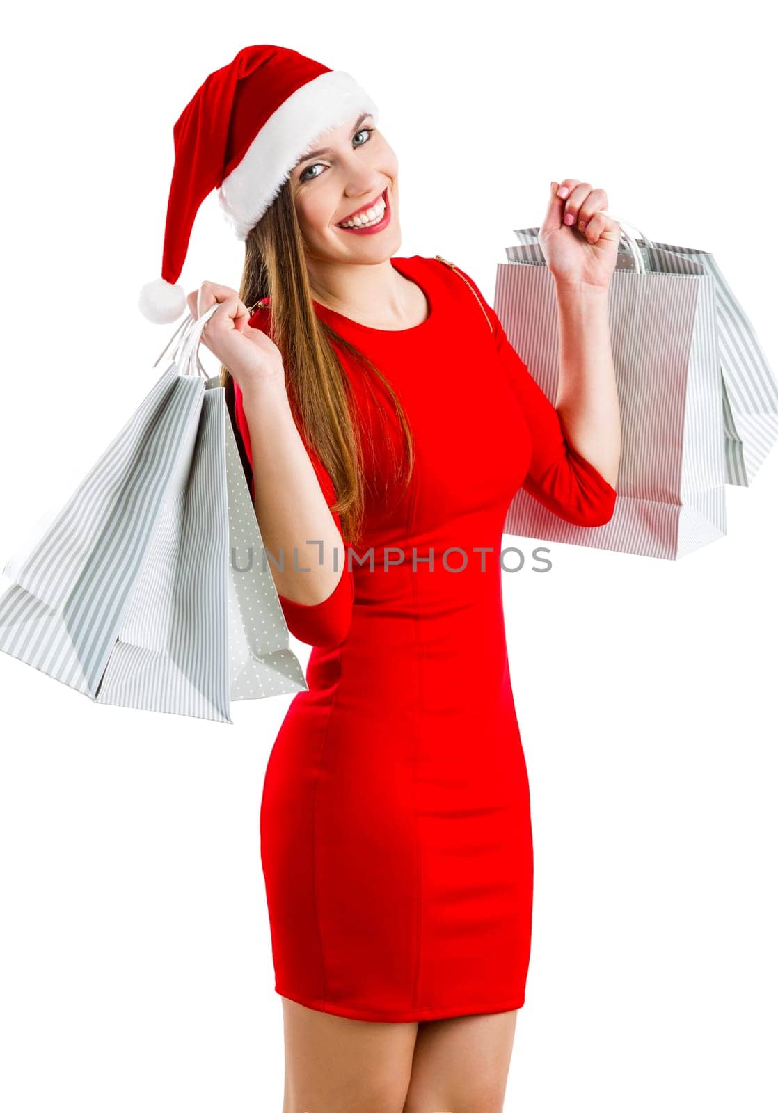 Beautiful and attractive woman with a santa hat holding shopping bags