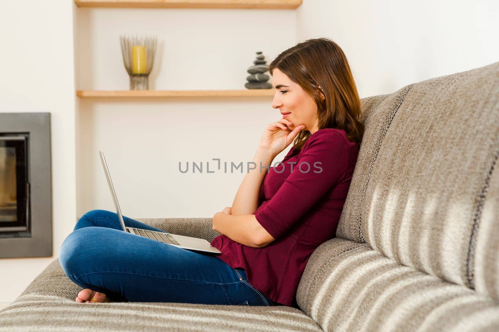 Beautiful woman working from the confort of home with her laptop