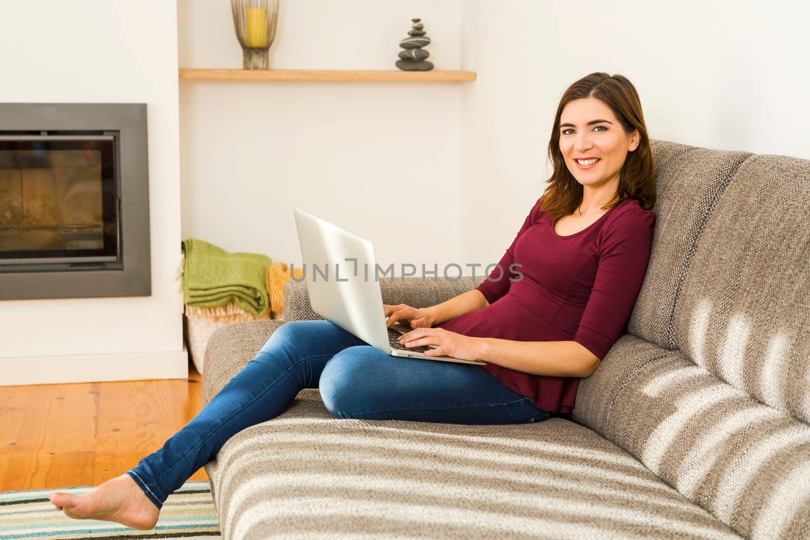 Beautiful woman working from the confort of home with her laptop