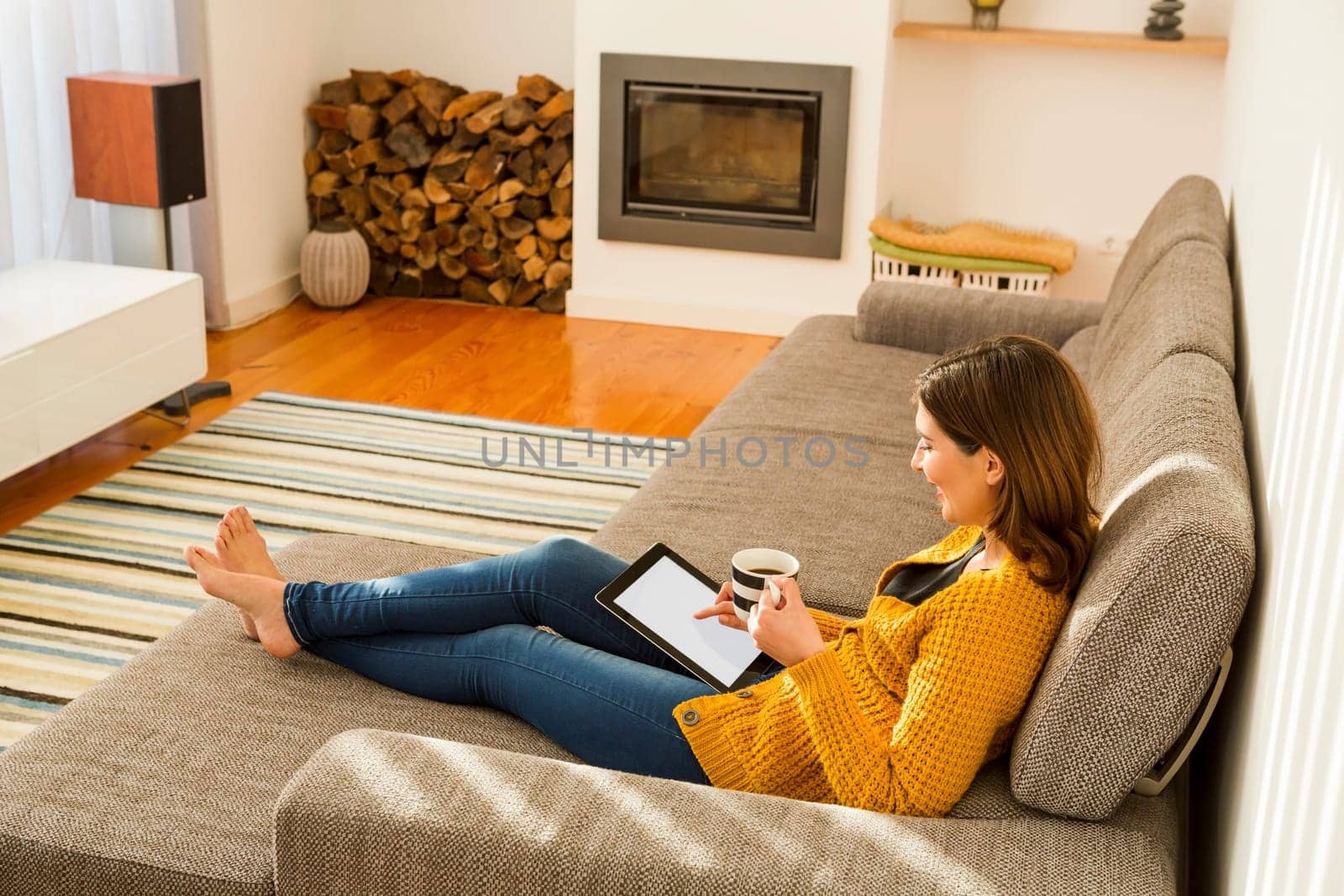 Beautiful young woman working with a tablet at home