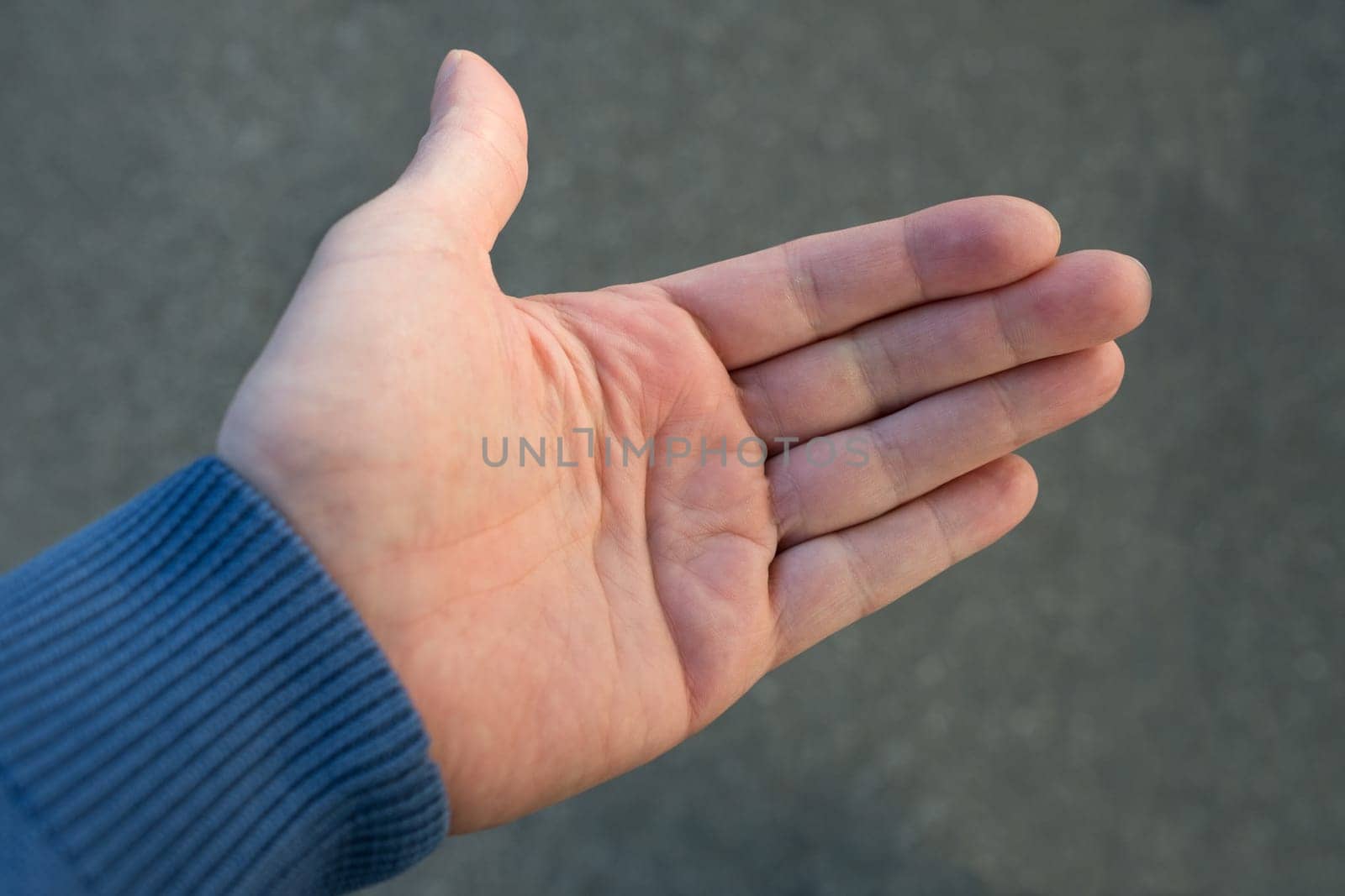 Open hand against grey fuzzy background