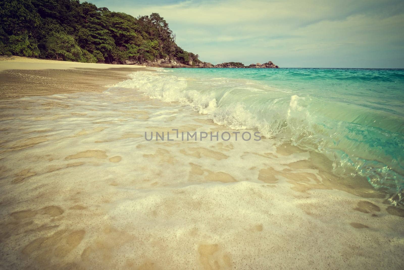 Vintage green tone style add texture effect beautiful landscape sky over the sea and waves on beach in summer at Koh Miang island, Mu Ko Similan National Park, Phang Nga province, Thailand