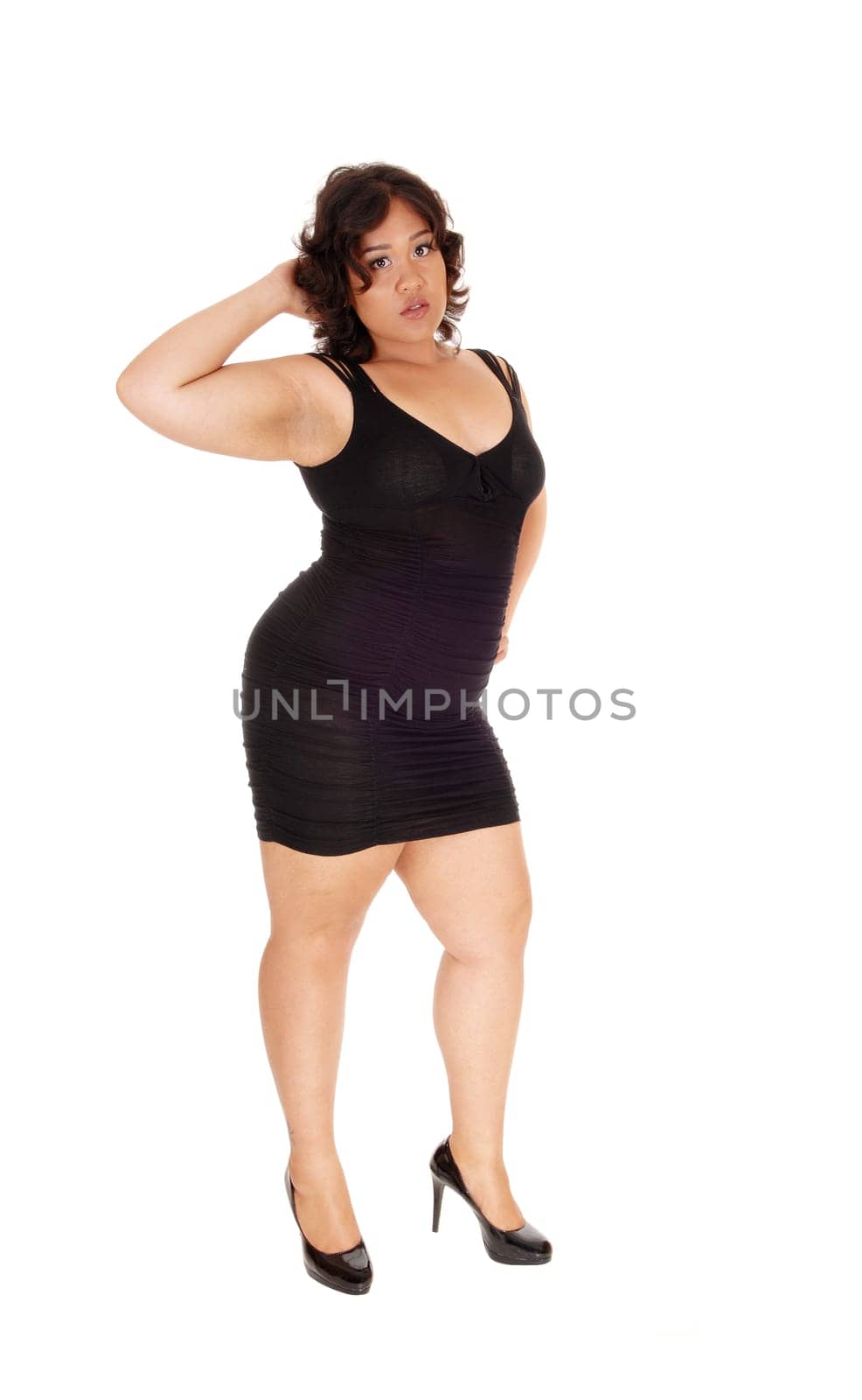 A young full size woman in a black dress with on hand on her head .standing isolated for white background..