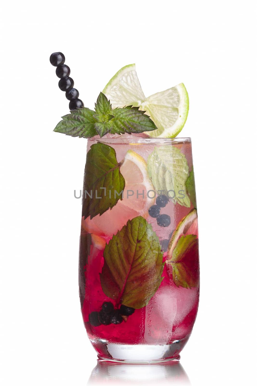 Blueberry mojito garnished with lime slice,skewered blueberries and fresh mint