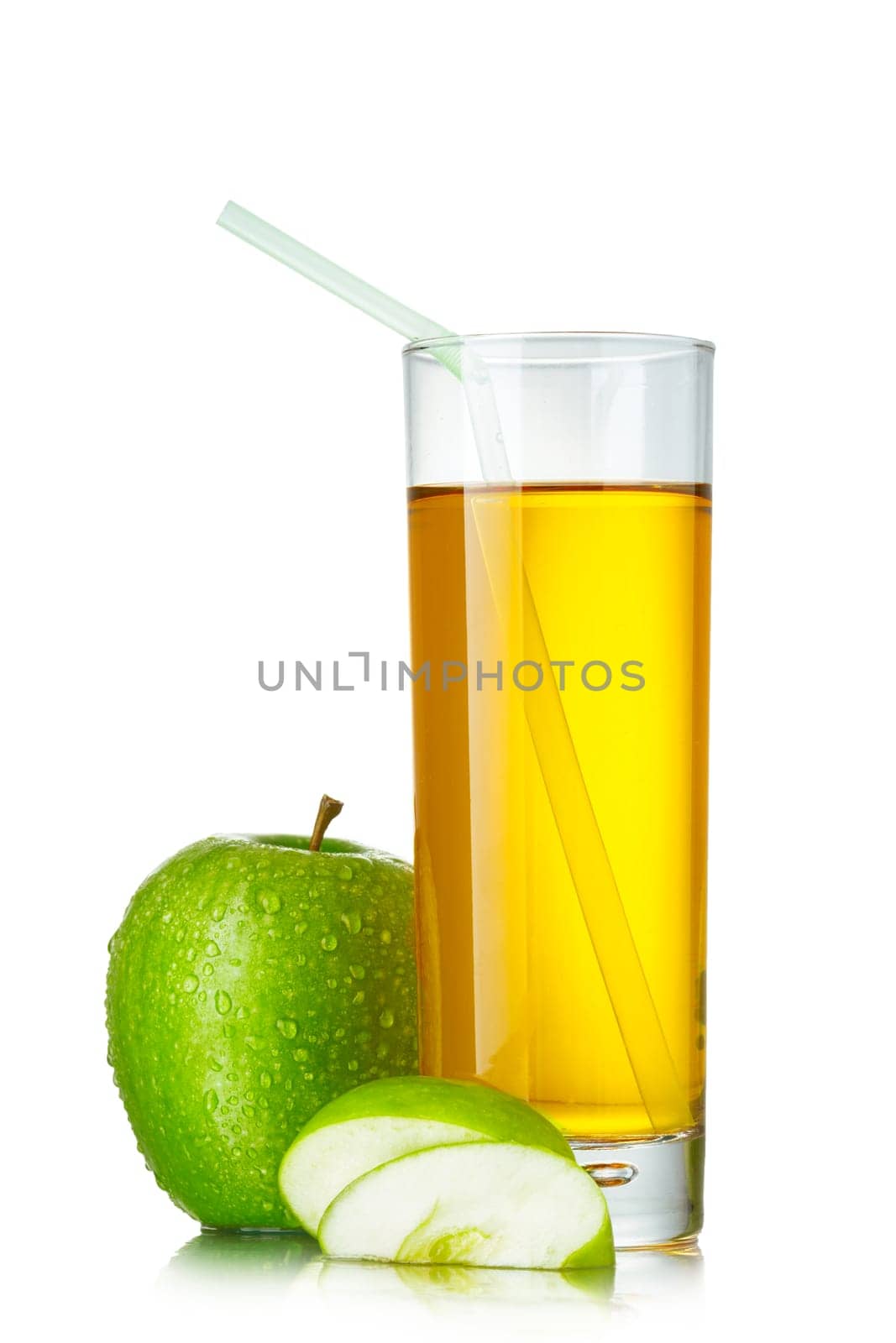 Fresh apple juice in highball glass with green apple and apple slices over plain white background