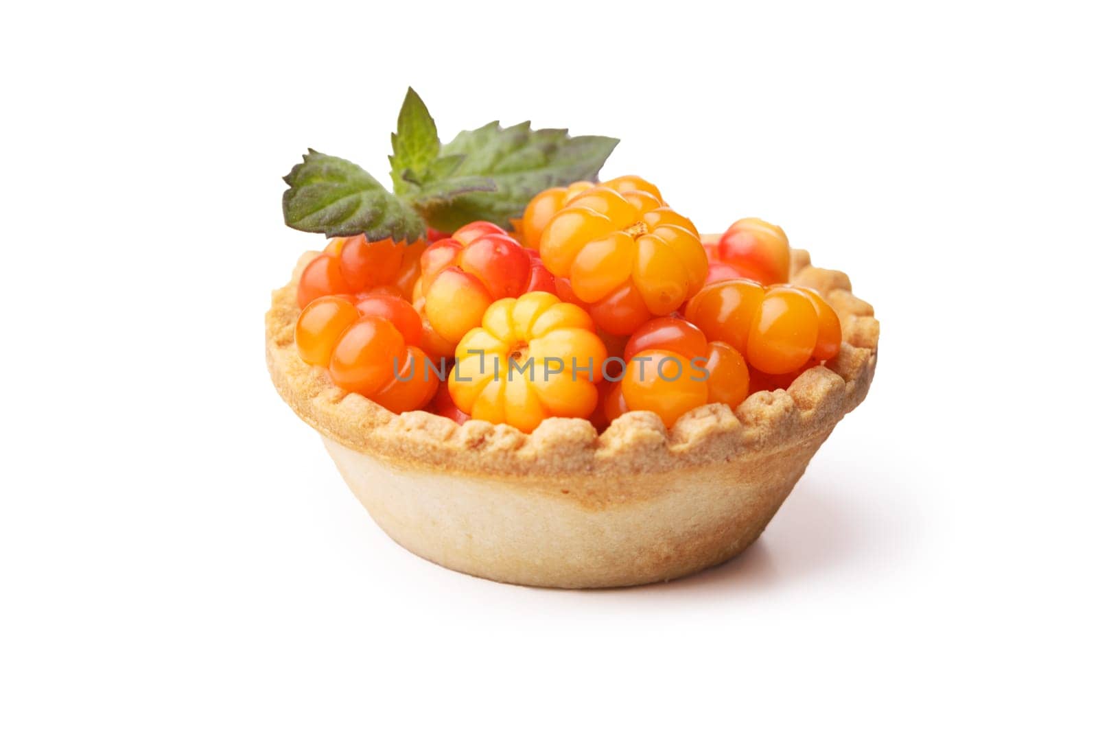 Cloudberry tart decorted with mint leaves. Sweet baked dessert with fresh wild cloudberries. Shallow depth of field
