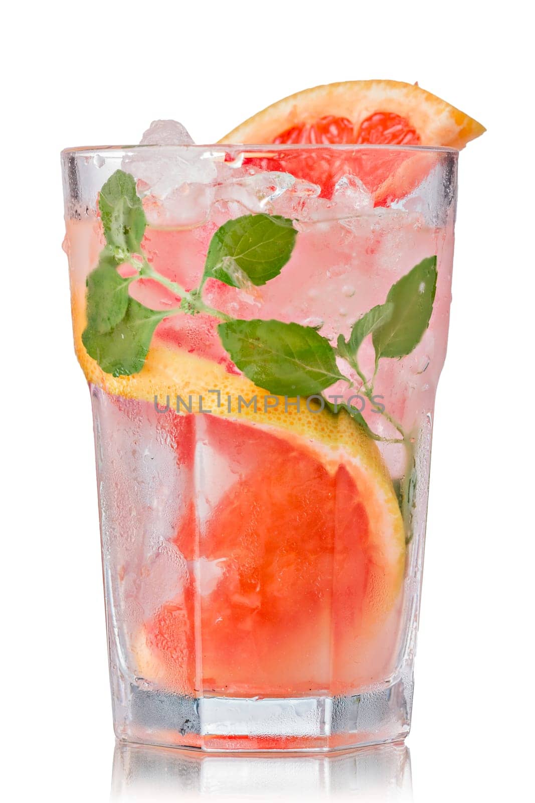 Grapefruit mojito cocktail in faceted highball. Refreshing summer drink with rum,grapefruit and fresh mint