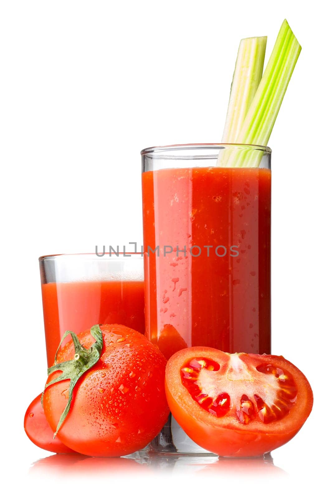 Fresh tomato juice with celery in highball glasses isolated on white