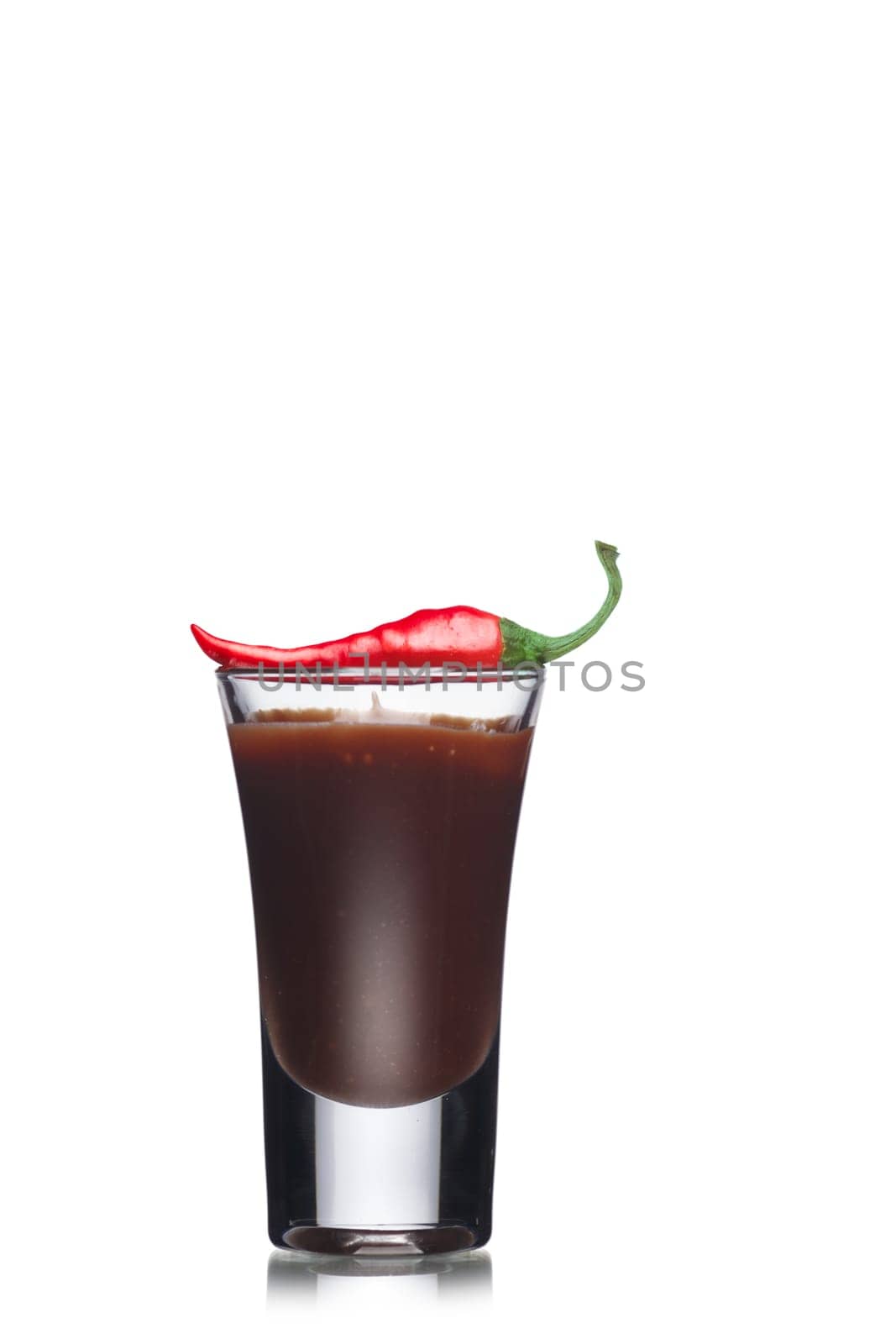 Dessert with chocolate decorated with red hot chilli pepper in a shot glass. Sweet food. Parfait