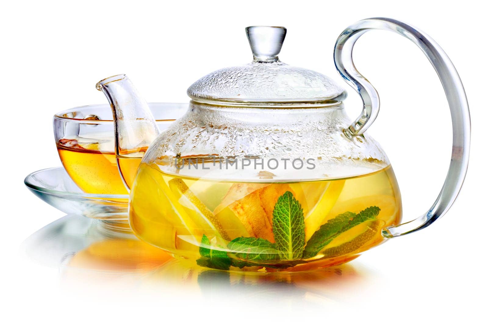Hot herbal tea with ginger, lemon and mint.  Ginger beverage in transparent teapot.