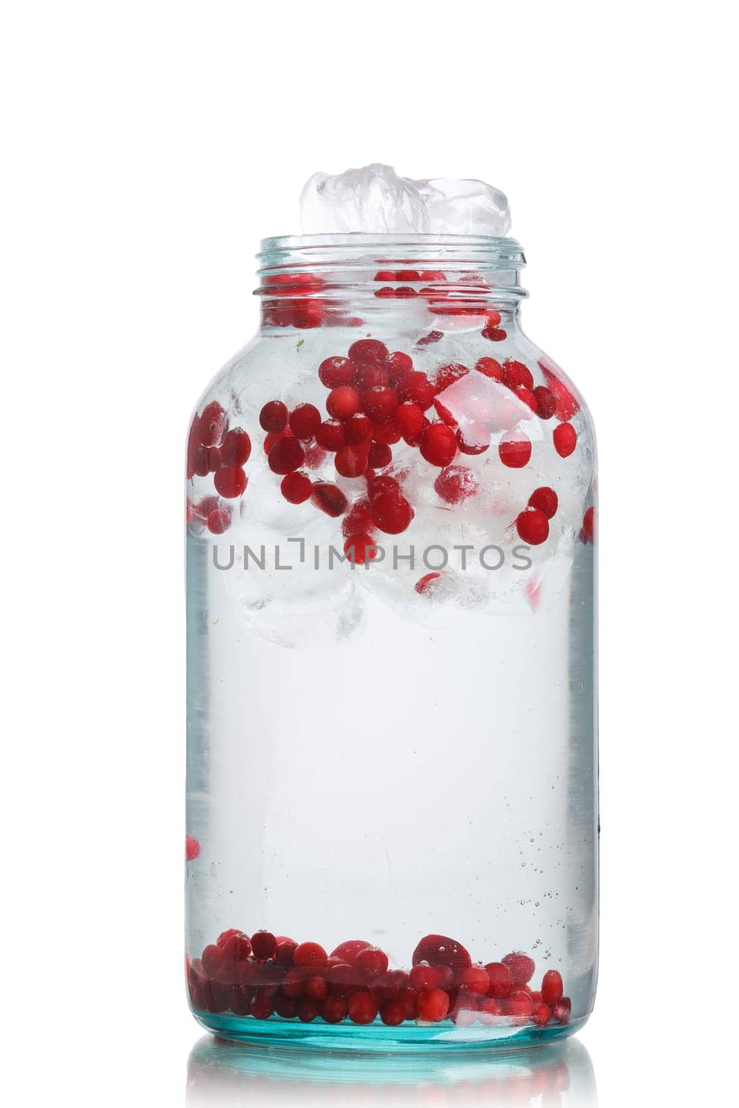 Cranberry  detox water in a glass jar. Healthy iced water with infused cranberry, cowberry and lemon