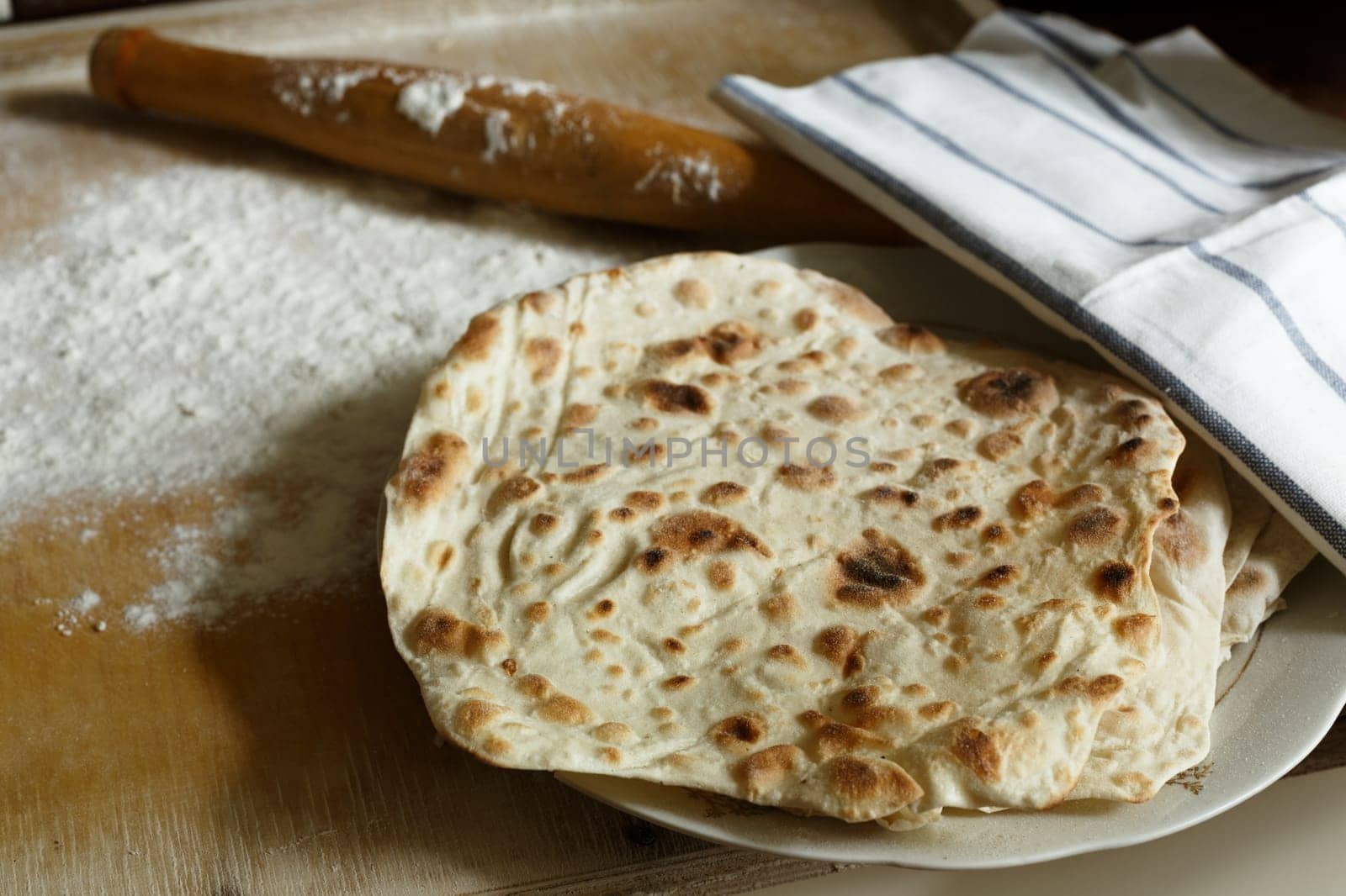 Traditional lavash (homemade armenian bread) on wooden table.