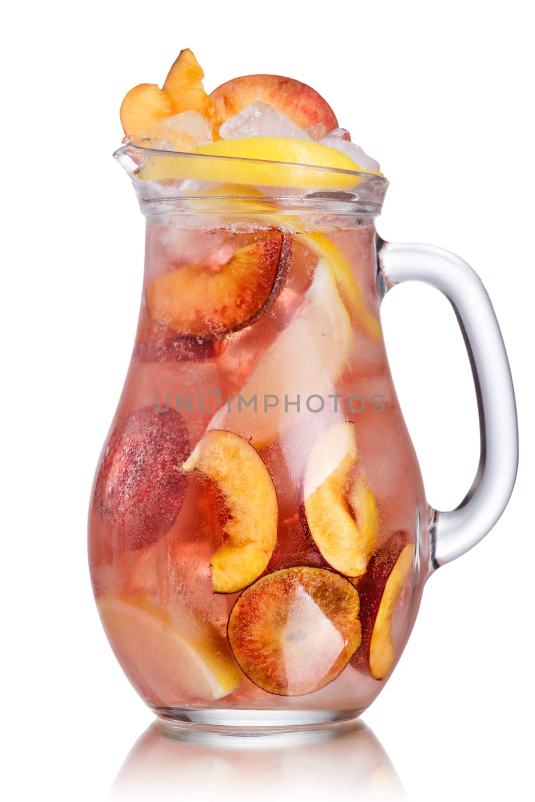 Pitcher of carbonated peach lemonade garnished with peach wheel and lemon slice. Jug full of cold peach spritzer with peach and lemon slices.