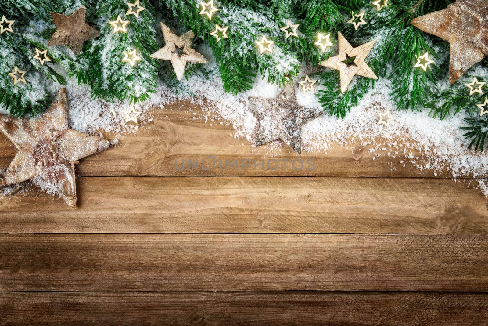 Christmas background in natural wood style,rustic,simple and elegant,with a border of fir branches,wooden stars and snow