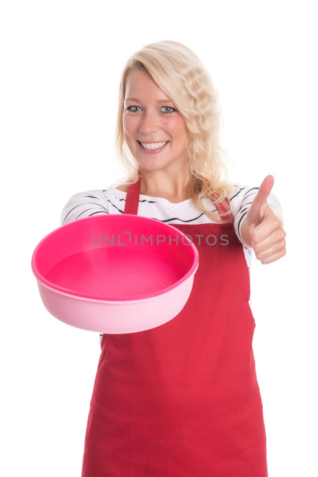 Woman in apron holds a silicone mold and shows thumbs up