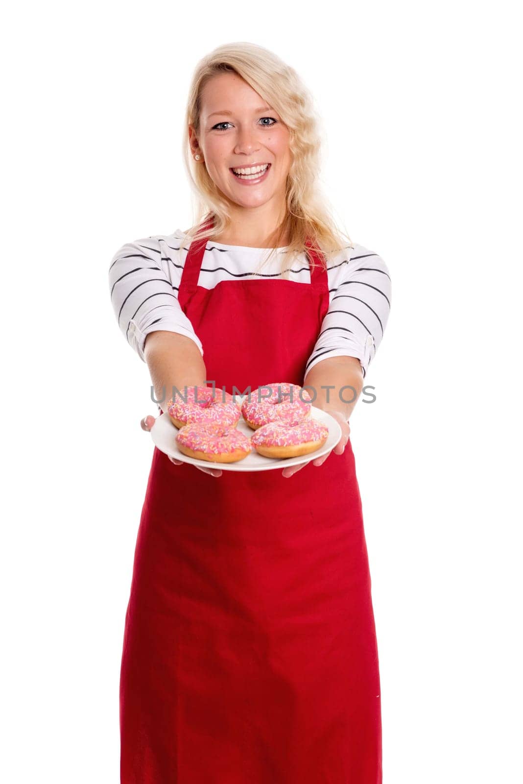Blonde woman in apron offers plates with doughnuts