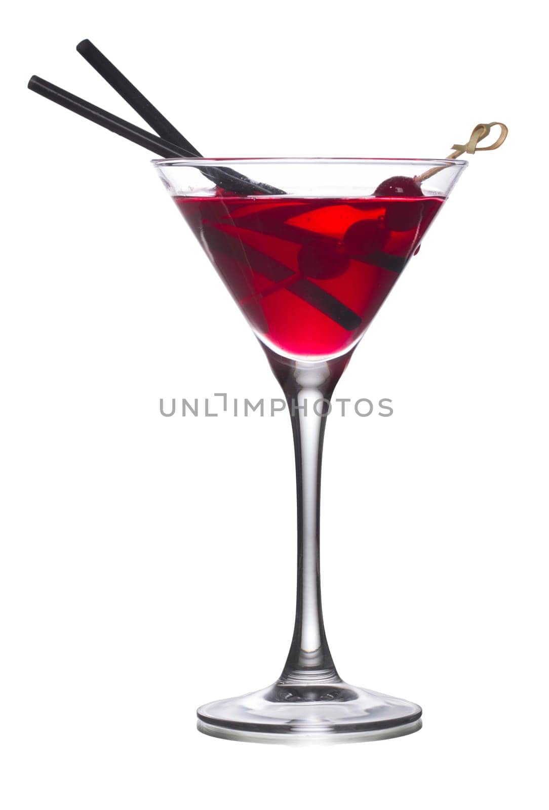 Cosmopolitan alcoholic cocktail decorated with black olives on a wooden skewer and black straws
