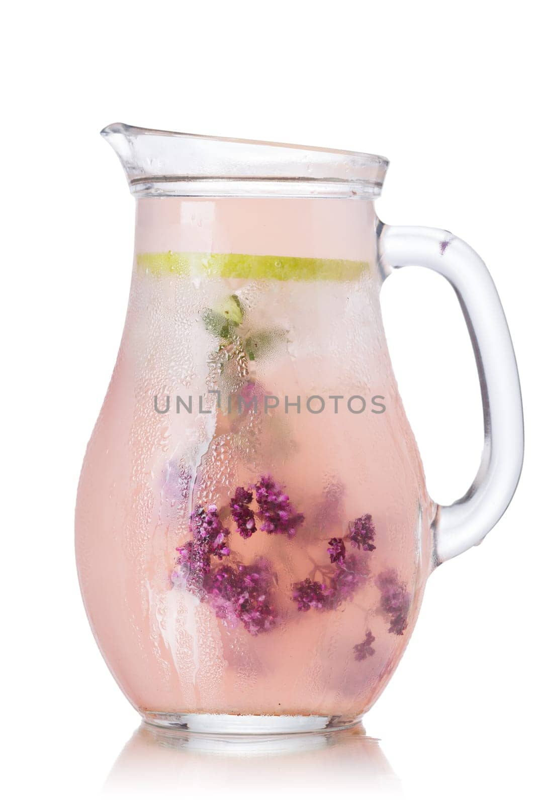 Blossoming oregano infused water. Pitcher of iced detox wated with wild marjoram (oregano)  Clean eating concept