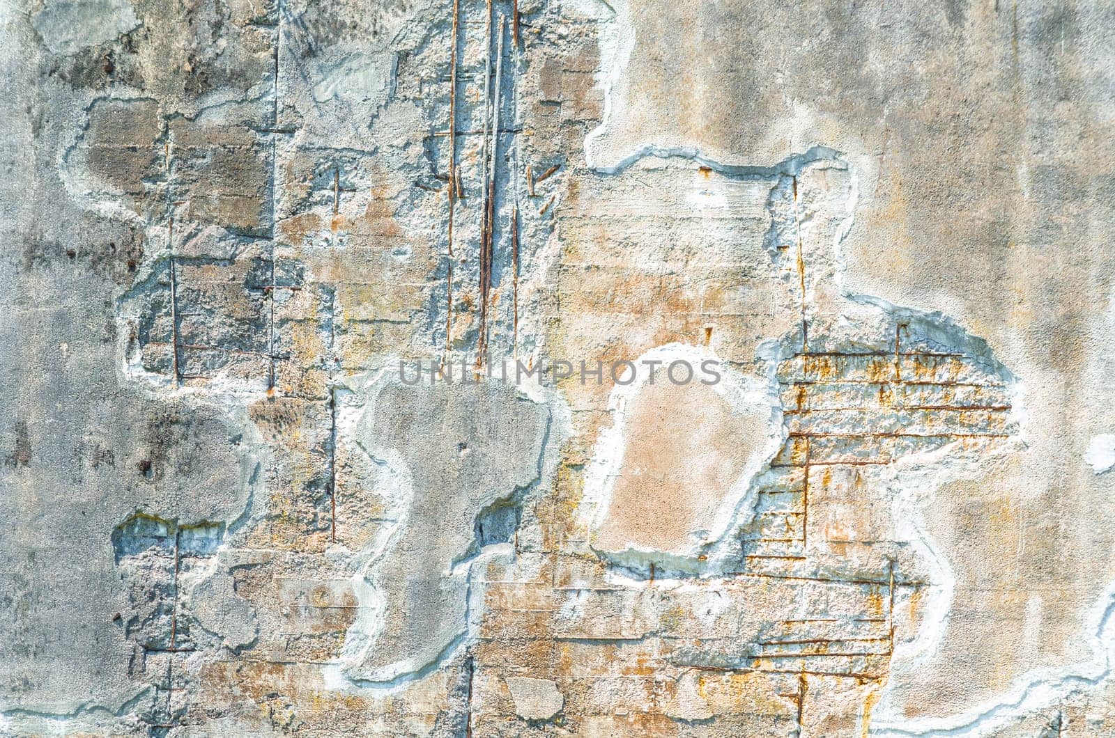 Old damaged and weathered concrete wall damaged by frost..
