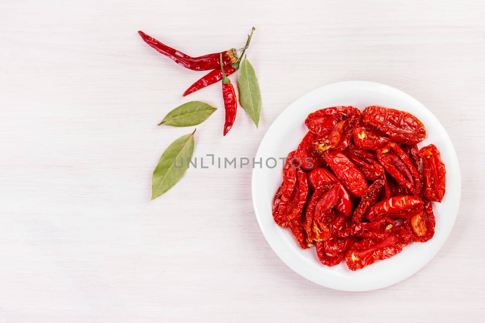 Sun dried tomatoes on bleached wooden table