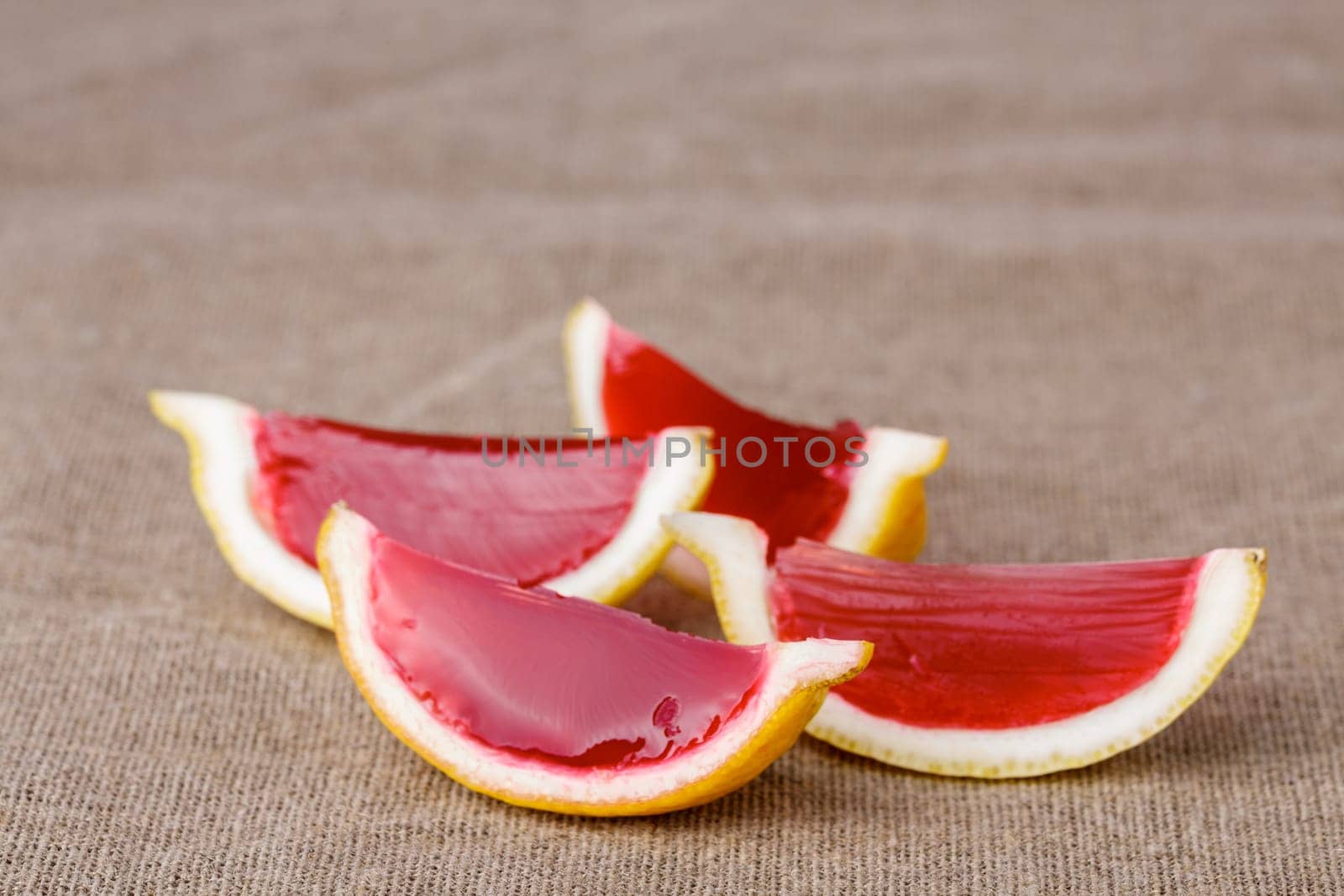 Lemon tequila strawberry jelly (jello) shots on a linen clothed table. Unusual adult party drinks