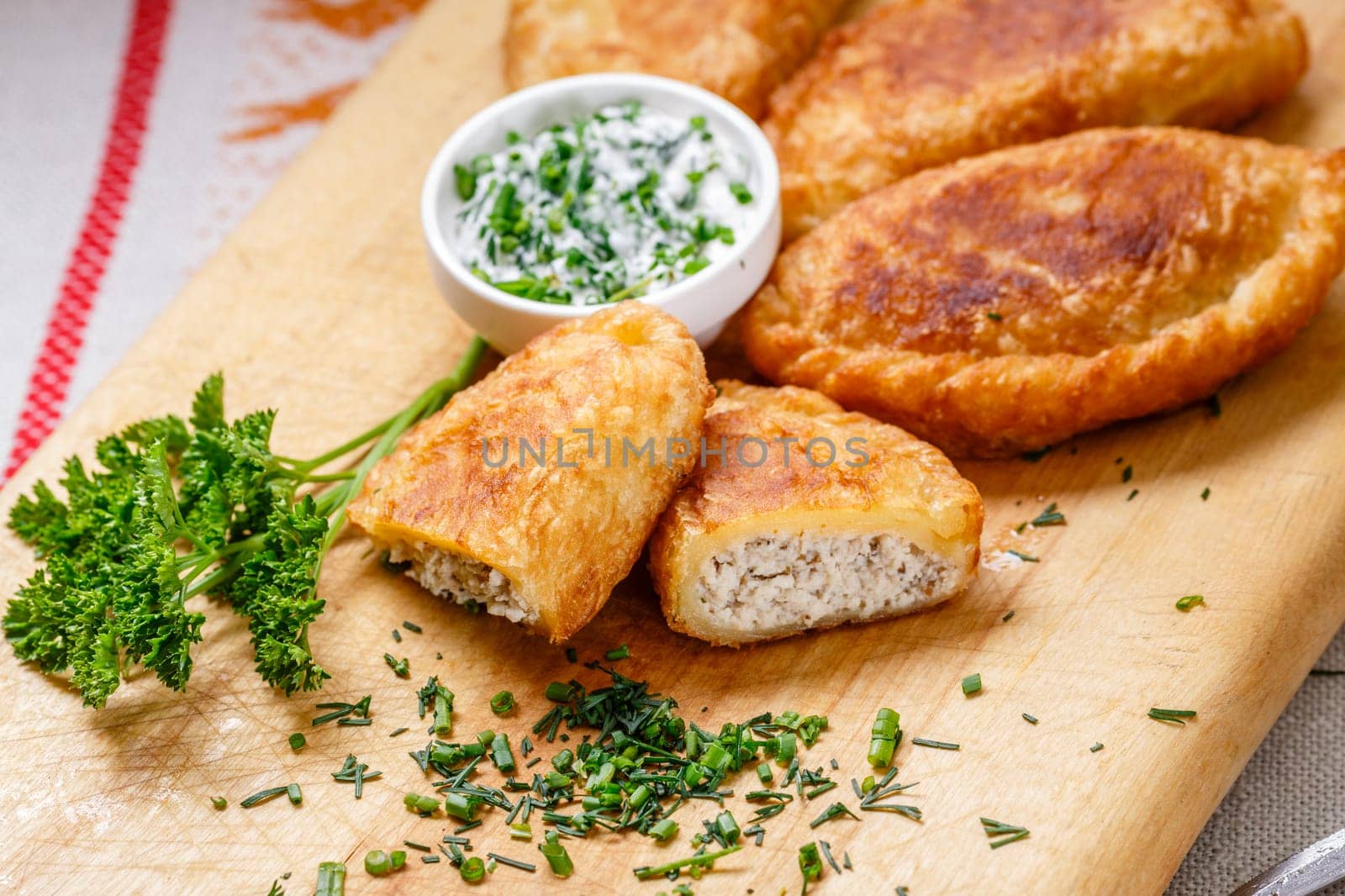 Colombian empanadas (snack sized savory patties) on wooden board. Latin cuisine