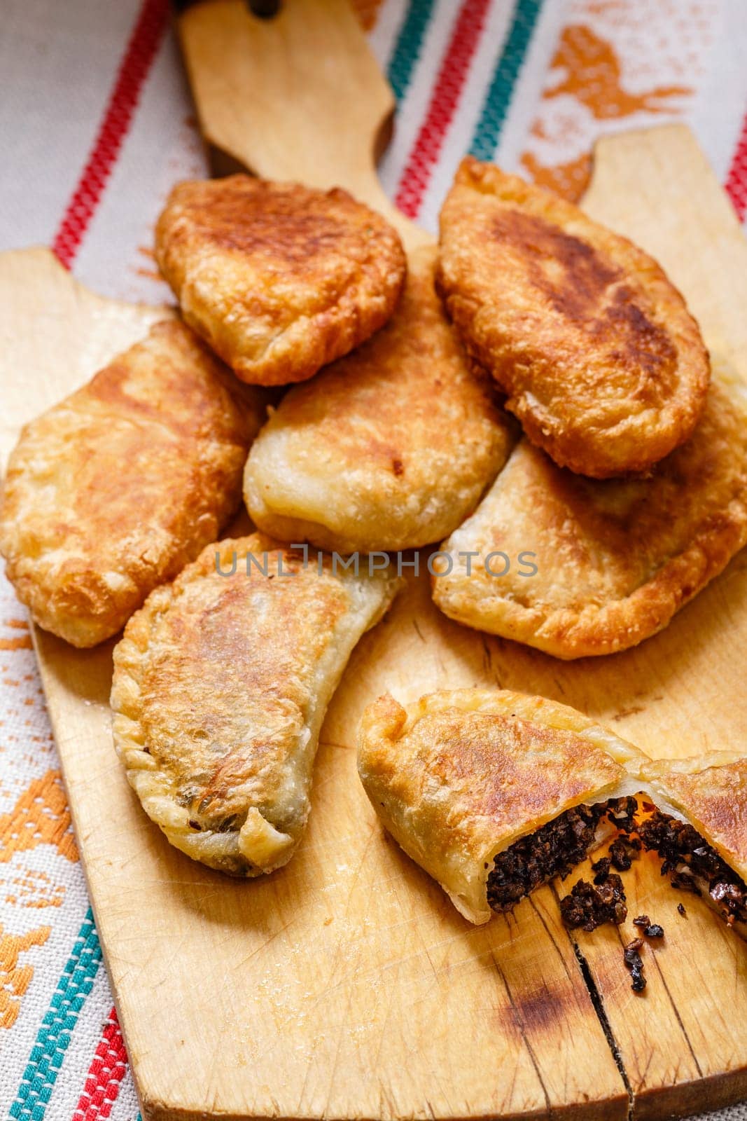Colombian empanadas (snack sized savory patties) on wooden board. Latin cuisine