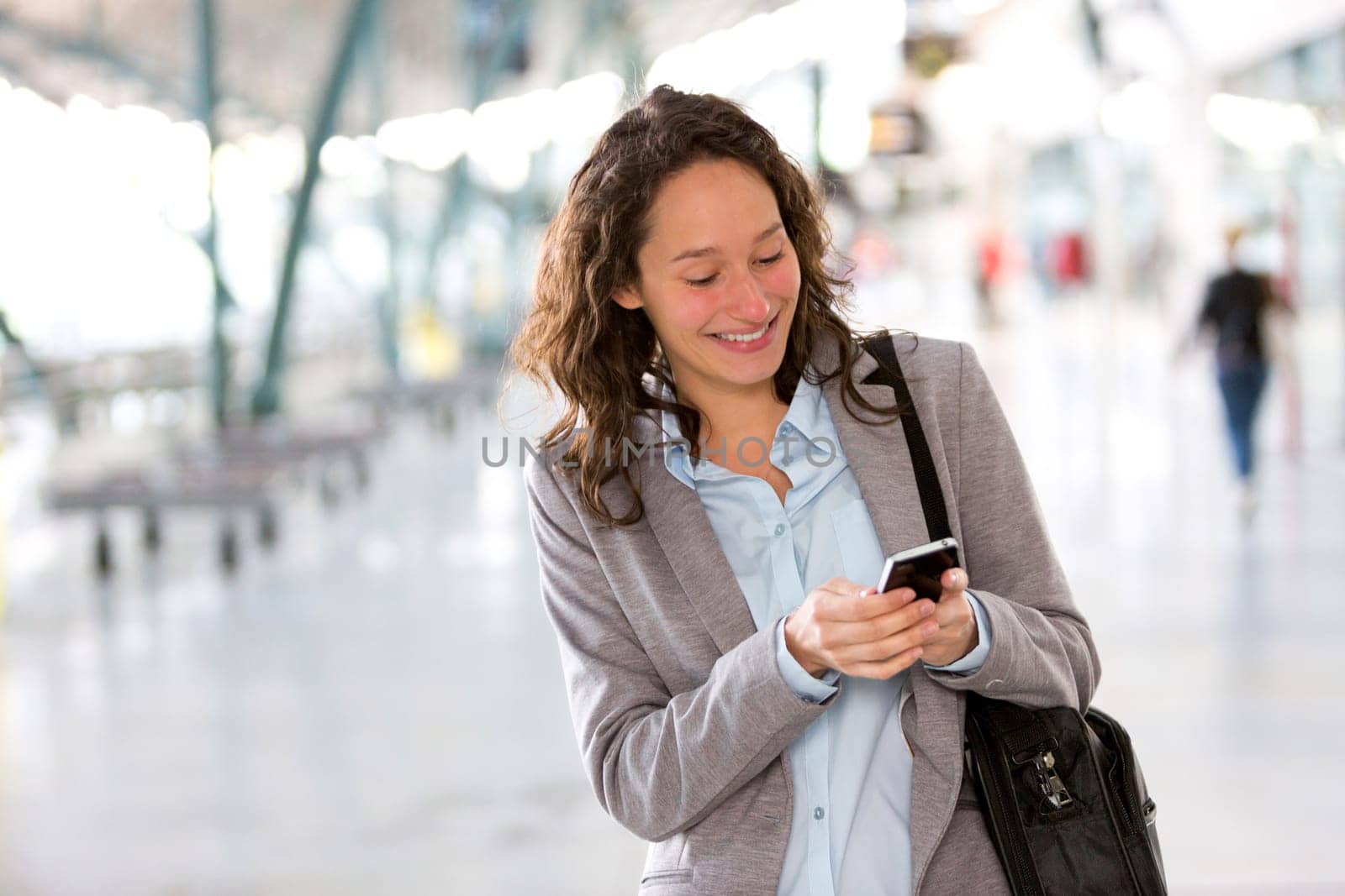 View of a Young attractive business woman using smartphone