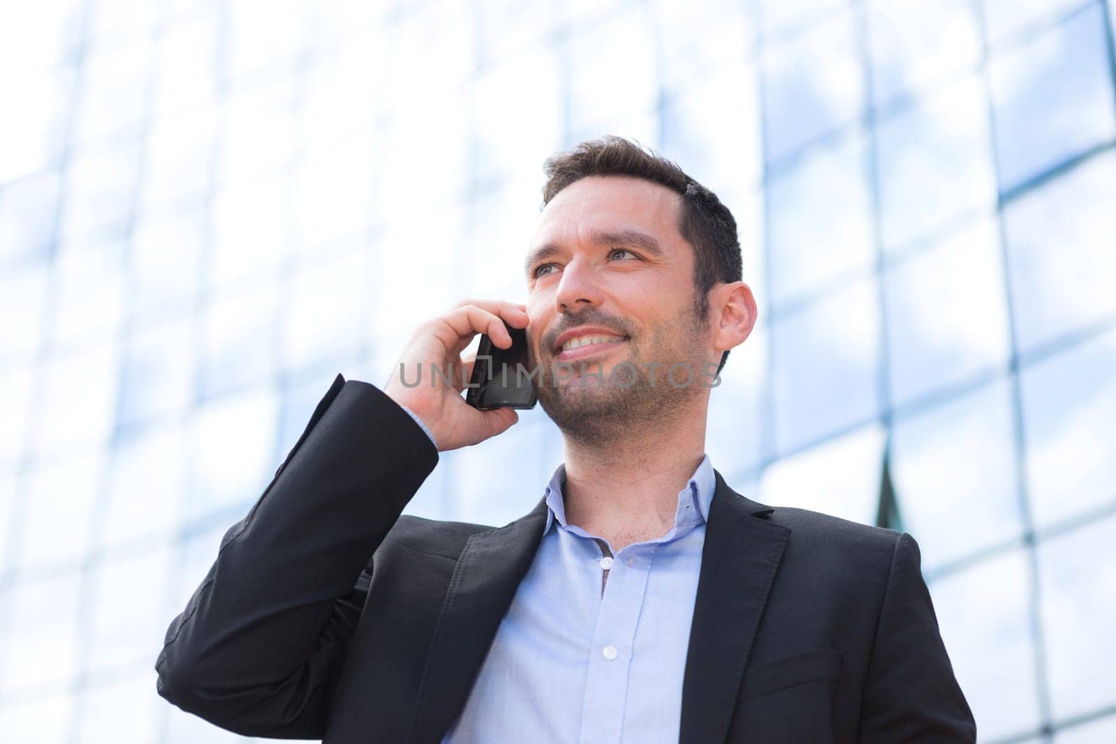 View of a Young attractive business man using smartphone