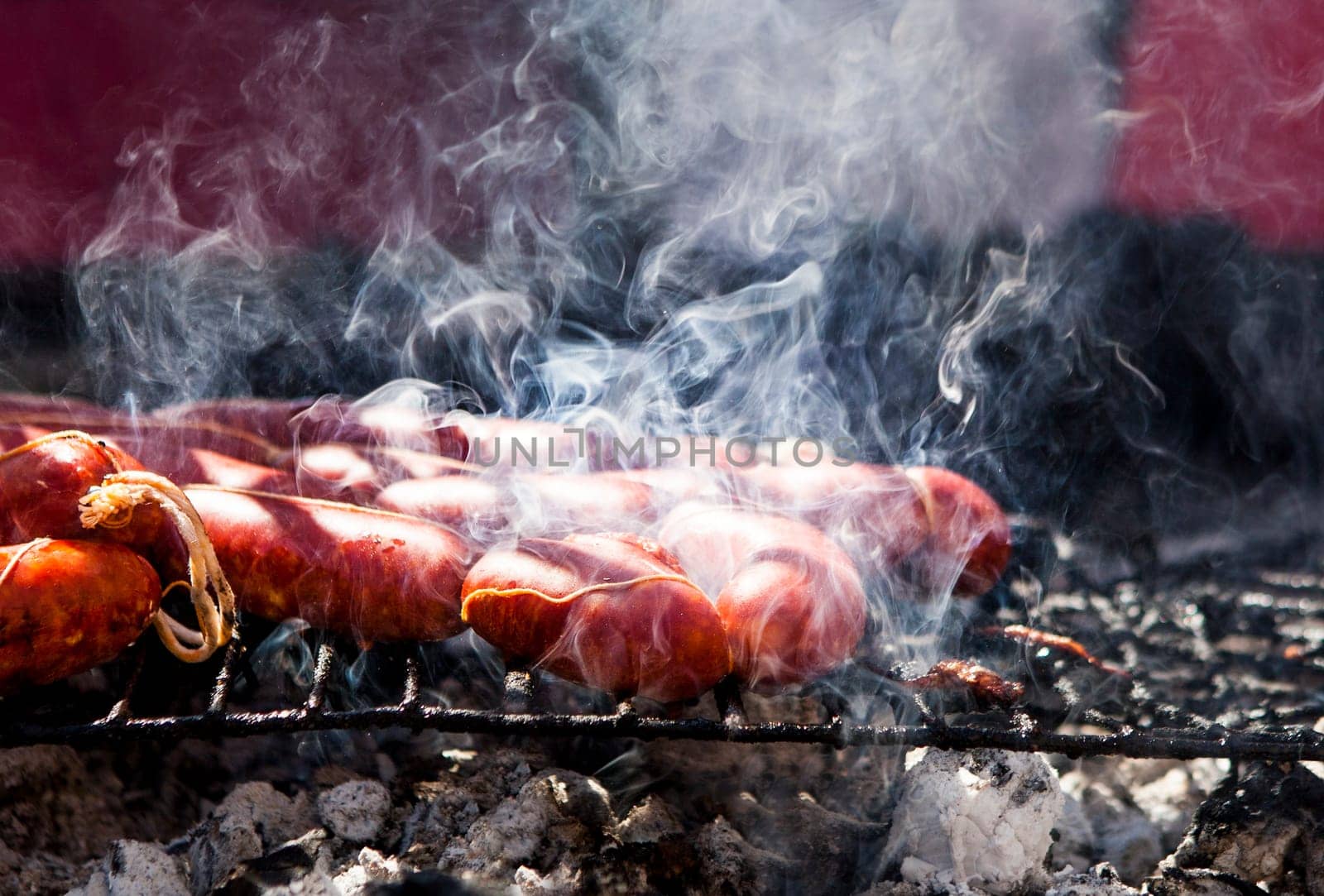 Close up view of many chorizos on a barbecue