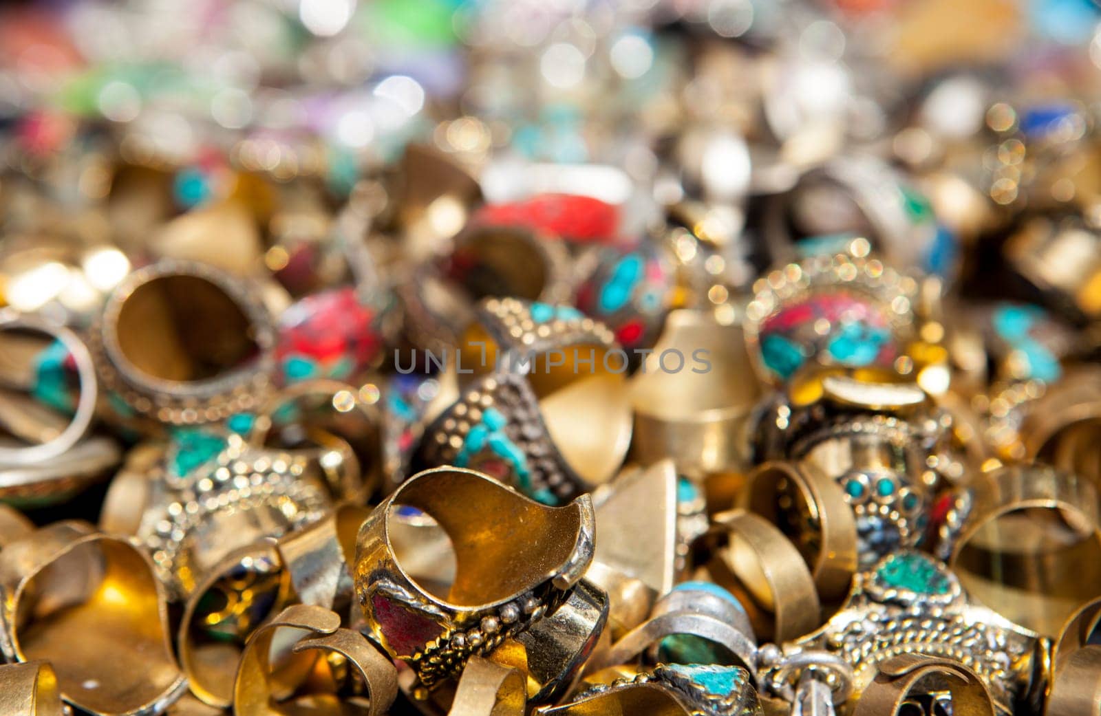 Loads of colorful rings of jewelry on street market stall