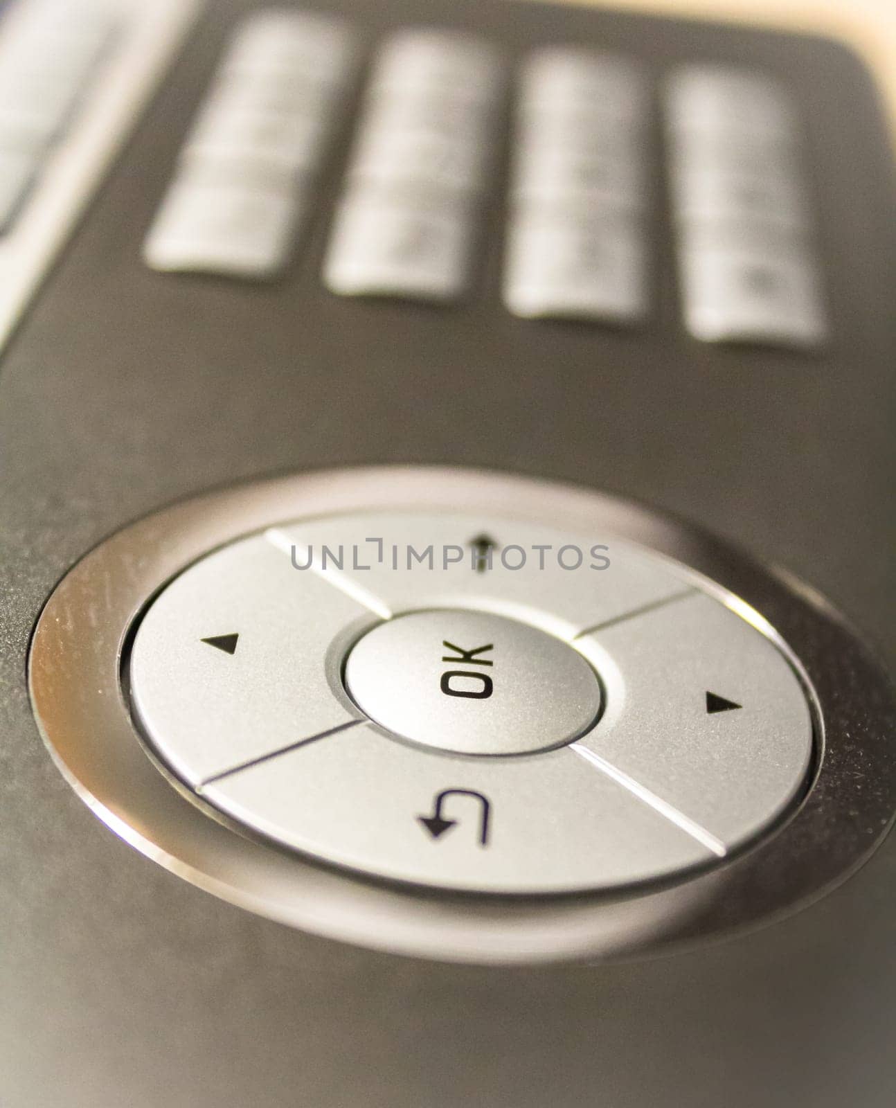 A grey phone with an OK button,close-up