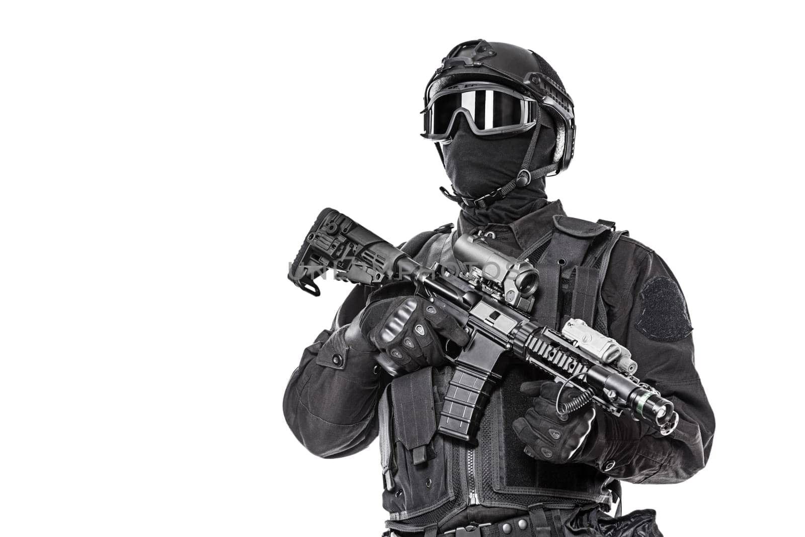 Spec ops police officer SWAT in black uniform and face mask studio shot